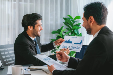 Busy analyst team discussing financial data on digital dashboard, analyzing chart and graph using data science software display on a laptop screen. Business intelligence and Fintech. Ferventの写真素材