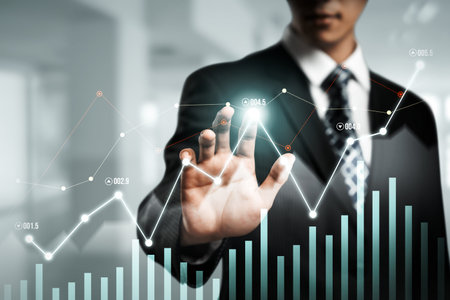 Businessman analyst working with digital finance business data graph showing technology of investment strategy for perceptive financial business decision. Digital economic analysis technology concept.の写真素材