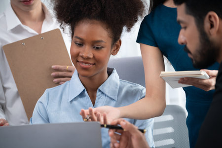 Young african businesswoman working together and discussing in corporate office with multicultural...