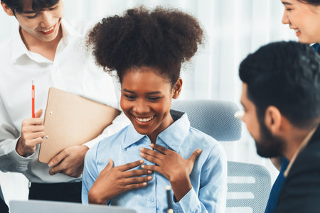 Happy diverse business people work together, discussing in corporate office. Professional and diversity teamwork discuss business plan on desk with laptop. Modern multicultural office worker. Concordの写真素材