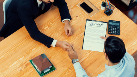 Top view real estate agent calculate tax and interest, discuss ownership term and insurance...