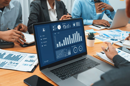 Multiracial analyst team use BI Fintech software to analyze financial data on meeting table....