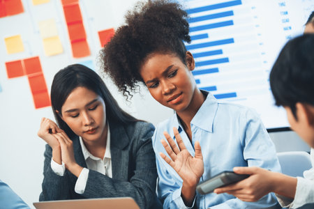 Diverse businesspeople analyzing financial dashboard data on laptop in serious meeting, confused and worried. Difficult challenge in corporate world. Hectic analysis or problem in workplace. Concordの写真素材