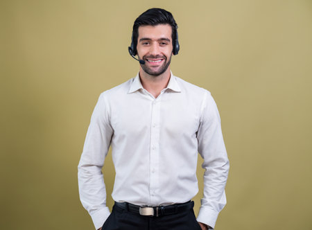 Male call center operator wearing headset and formal suit standing confidently on isolated background portrait. Professional smile and service minded for customer service and support. ferventの写真素材