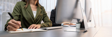 Professional business people working on computer in corporate workplace. Office worker working in...