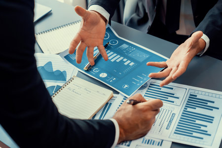 Closeup busy analyst team discussing financial data on digital dashboard, analyzing chart and graph using data science software display on a laptop screen. Business intelligence and Fintech. Ferventの写真素材