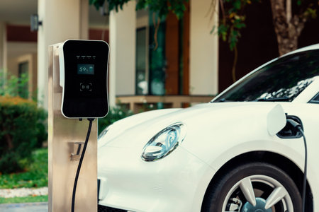 Progressive concept of EV car and home charging station powered by sustainable and clean energy with zero CO2 emission for green environmental. Charging point at residential area for electric vehicle.の写真素材
