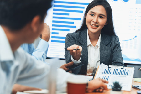 Young asian businesswoman presenting data analysis dashboard on TV screen in modern meeting. Business presentation with group of business people in conference room. Concordの写真素材