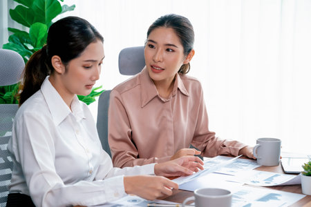 Analyst team colleagues discuss financial data on digital dashboard, analyzing charts and graph with supportive teamwork. Professional office use business intelligence to plan marketing. Enthusiasticの写真素材