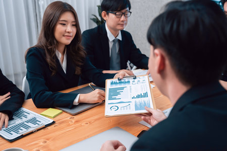 Business team of financial data analysis meeting with business intelligence, report paper and dashboard on laptop for marketing strategy. Business people working together to promote harmony in office.の写真素材