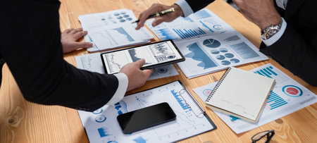 Closeup busy analyst team discussing financial data on digital dashboard, analyzing chart and graph...