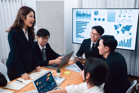 Business team of financial data analysis meeting with business intelligence, report paper and dashboard on laptop for marketing strategy. Business people working together to promote harmony in office.の写真素材
