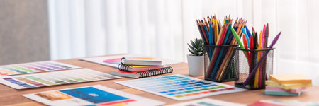 Panorama shot of various color palette idea papers arranged neatly on workspace table for graphic...