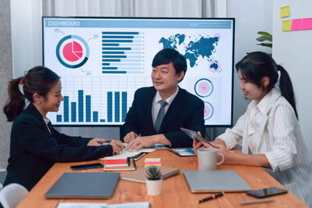 Business team of financial data analysis meeting with business intelligence, report paper and dashboard on laptop for marketing strategy. Business people working together to promote harmony in office.の写真素材