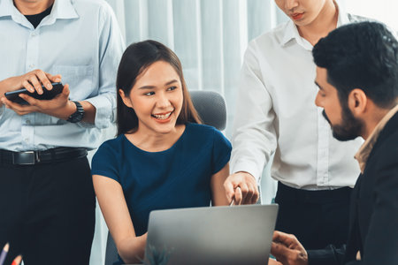 Professional Asian employee work together as team in corporate office, discussing business plans and...