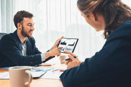 Busy analyst team in office analyzing financial data analysis for marketing strategy in workspace using BI dashboard with graph and chart on tablet screen to improve business performance. Entityの写真素材
