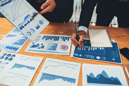 Closeup busy analyst team discussing financial data on digital dashboard, analyzing chart and graph using data science software display on a laptop screen. Business intelligence and Fintech. Ferventの写真素材