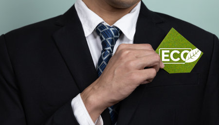 Eco-friendly corporate promoting sustainable and green business concept with businessman hold ECO symbol paper as environmental protection commitment using clean energy with zero CO2 emission. Alterの写真素材