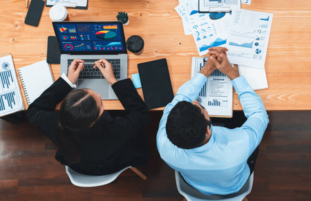 Top view multiracial analyst team use BI dashboard display on laptop screen, analyzing financial data for strategic decision. Fintech analyzes marketing indicators. Concordの写真素材