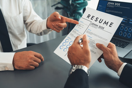 Interviewing job applicant in office with resume paper. Candidate wear suit for formal conversation with interviewer. Recruitment process with question about career and work experience. Ferventの写真素材