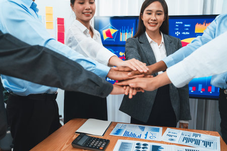 Multiracial office workers hand stack shows solidarity, teamwork and trust in diverse community. Businesspeople unite for business success through synergy and collaboration by hand stacking. Concordの写真素材