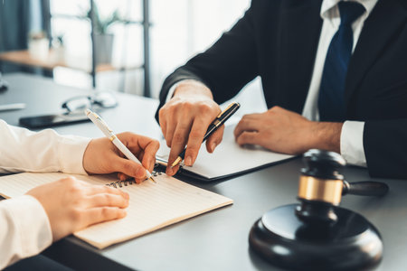 Lawyer colleagues or legal team working or drafting legal document at law firm office desk. Gavel hammer for righteous and equality judgment by lawmaker and attorney. Equilibriumの写真素材
