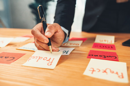 Businessman brainstorming and writing creative idea on colorful notes. Planning and brainstorm strategy to achieve business targets using post notes. ferventの写真素材