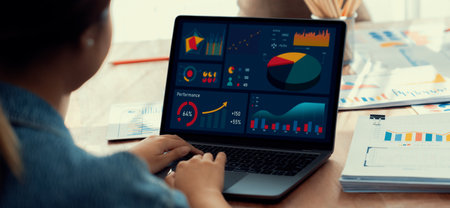 Panorama shot analyst team utilizing BI Fintech to analyze financial report with laptop. Businesspeople analyzing BI power dashboard displayed on laptop screen for business insight. Scrutinizeの写真素材