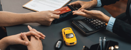 Customer client purchases new car with credit card via electronic terminal after finishing the deal...