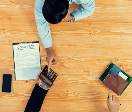 Top view real estate agent calculate tax and interest, discuss ownership term and insurance...
