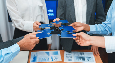 Corporate officer worker collaborate in office, connecting puzzle pieces with report paper on table...