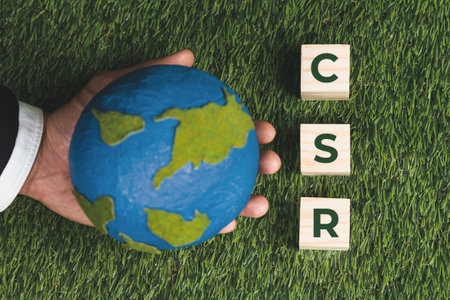 Top view businessman hand holding paper globe with CSR symbol cube. Eco-friendly green and ethical business company with no CO2 emission policy. Corporate social responsible for green community. Alterの写真素材
