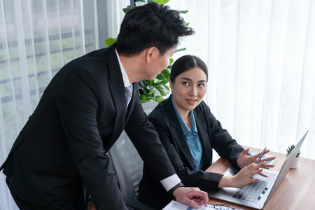 Busy analyst team in office discuss data analysis and marketing strategy using BI dashboard and statistics on laptop screen to improve business performance at meeting with strong teamwork. Jubilantの写真素材