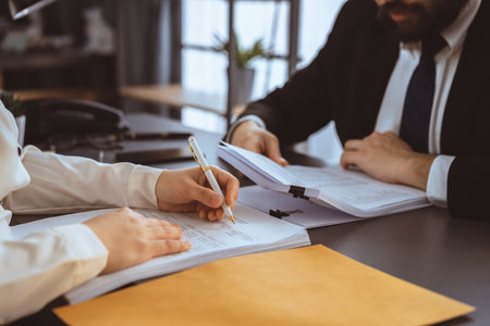 Businesspeople working in the office on official corporate papers, office workers reviewing stack of financial documents and working on business report. Equilibriumの写真素材