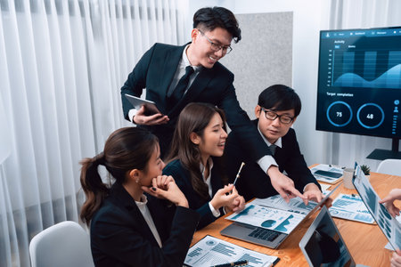 Business team of financial data analysis meeting with business intelligence, report paper and dashboard on laptop for marketing strategy. Business people working together to promote harmony in office.の写真素材
