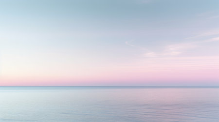 Clear blue sky sunset with glowing pink and purple horizon on calm ocean seascape background. Picturesqueの写真素材