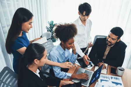 Multiracial analyst team use BI Fintech software to analyze financial data on meeting table. Financial dashboard data display on laptop screen with analyzed chart for marketing indication. Concordの写真素材