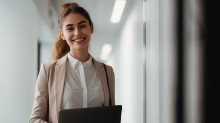 Ambitious and positive businesswoman, smiling face, holding laptop, standing in office. Generative AI AIG20.の素材