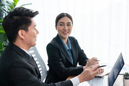 Busy analyst team in office discuss data analysis and marketing strategy using BI dashboard and statistics on laptop screen to improve business performance at meeting with strong teamwork. Jubilantの写真素材