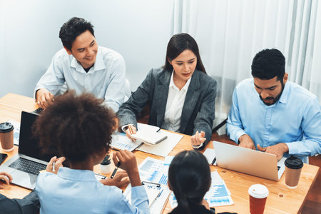 Multiracial analyst team use BI dashboard data to analyze financial report on meeting table. Group of diverse business people utilize data analysis by FIntech for success business marketing. Concordの写真素材