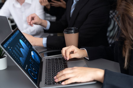 Business team analyze business analytic or business intelligence dashboard on laptop screen show graph and chart with statistic in harmony office. Analyst team meeting researching, planning strategy.の写真素材