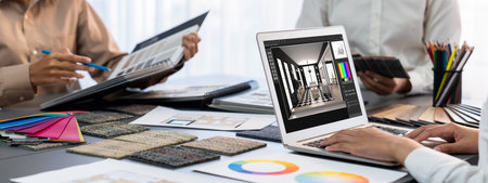 Group of interior architect designer team at table choosing color samples with architecture software...