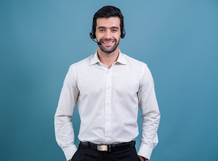 Male call center operator wearing headset and formal suit standing confidently on isolated background portrait. Professional smile and service minded for customer service and support. ferventの写真素材