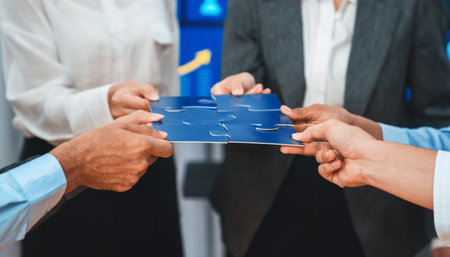 Corporate officer worker collaborate in office, connecting puzzle pieces with report paper on table...