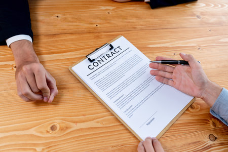 Executives sign contract in meeting room. Business people seal deal on paper. Successful agreement between two business partnership with signature signed on legal document. Jubilantの写真素材