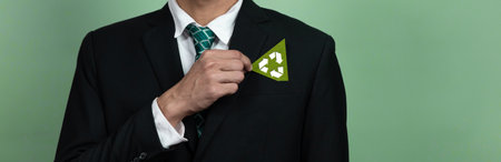 Corporate promoting sustainable and green business concept with businessman holding Recycle symbol...