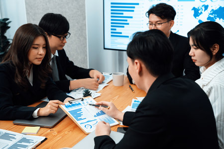 Business team of financial data analysis meeting with business intelligence, report paper and dashboard on laptop for marketing strategy. Business people working together to promote harmony in office.の写真素材