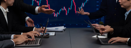 Group of stock trading investor or business people discussing and analyzing financial data graph on stock market together in meeting room. Stock trading or exchange investment planning. Trailblazingの写真素材