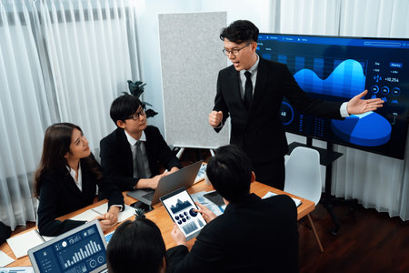 Confidence and asian businessman give presentation on financial analyzed by business intelligence in dashboard report to other people in board room meeting to promote harmony in workplace.の写真素材