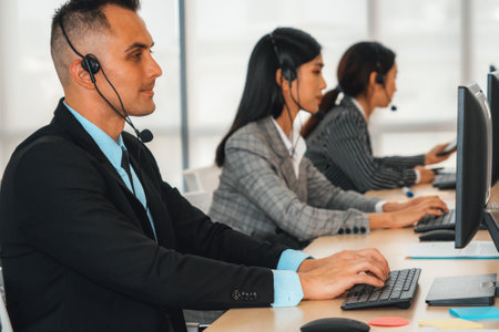 Business people wearing headset working in office to support remote customer or colleague. Call center, telemarketing, customer support agent provide service on telephone video conference call. Jivyの写真素材